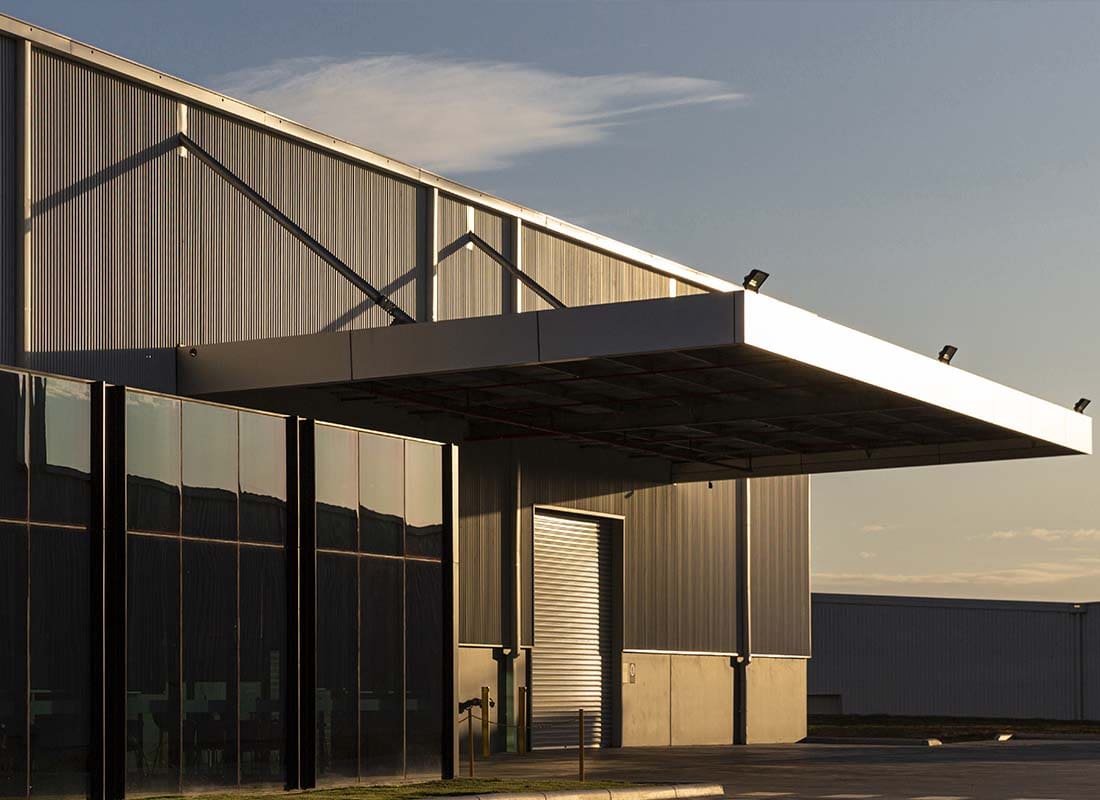 Vacant Building Insurance - New Commercial Property Building for Small Warehouse Sitting Vacant on a Sunny Day at Dusk